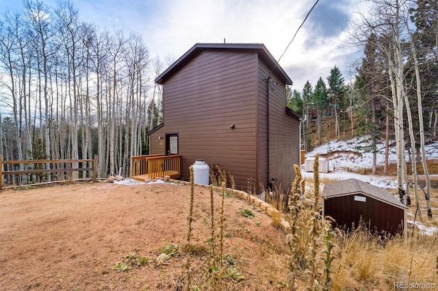 view of side of property featuring a shed