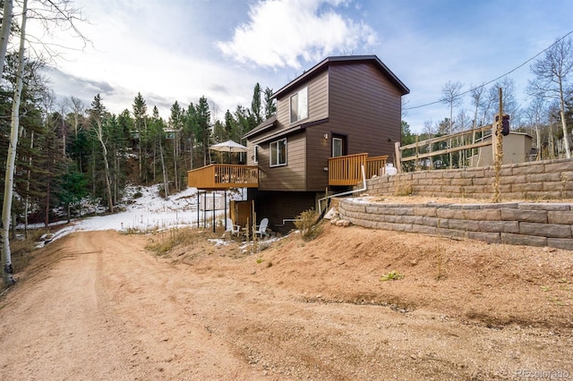 view of side of home with a wooden deck