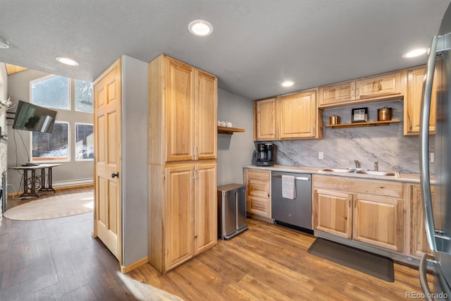 kitchen featuring sink, light wood-type flooring, light brown cabinets, and appliances with stainless steel finishes