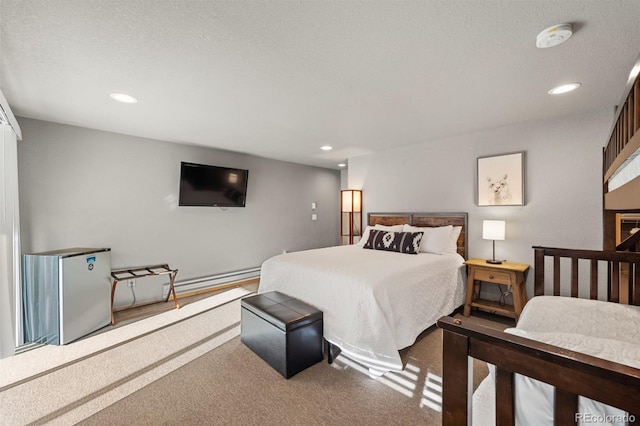 bedroom featuring stainless steel refrigerator, carpet flooring, and a textured ceiling