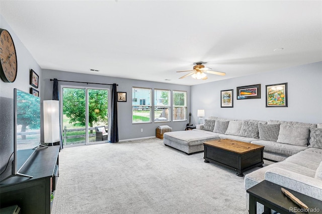 carpeted living room featuring ceiling fan