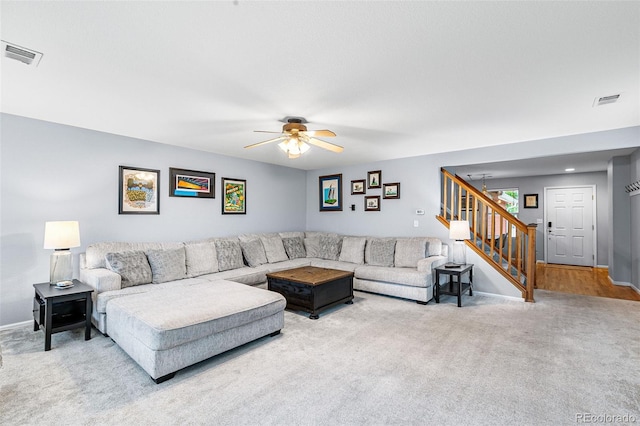 living room with light carpet and ceiling fan