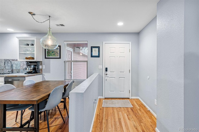 interior space featuring sink and light hardwood / wood-style floors