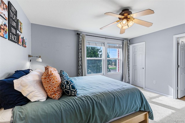 carpeted bedroom with ceiling fan