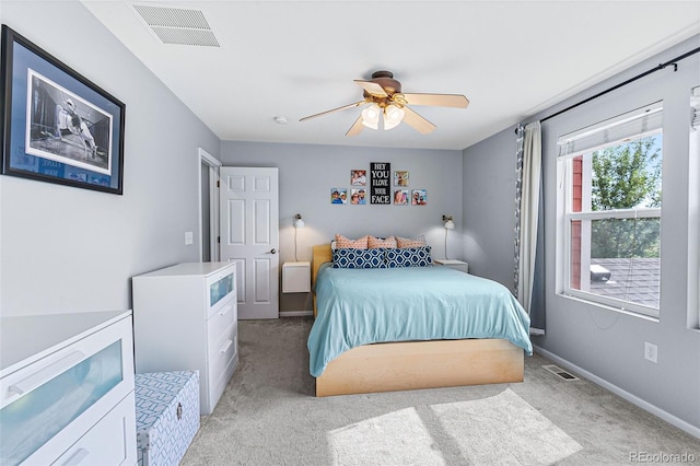 bedroom with ceiling fan and light colored carpet