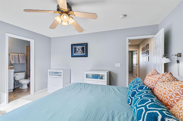 bedroom with light colored carpet, ceiling fan, and ensuite bathroom