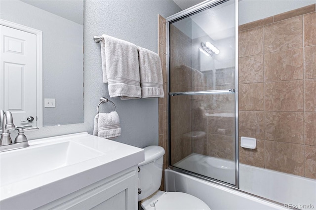 full bathroom featuring toilet, vanity, and shower / bath combination with glass door