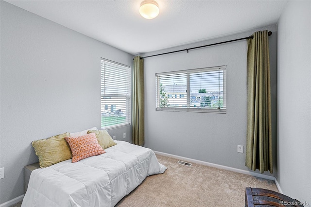 bedroom with light colored carpet