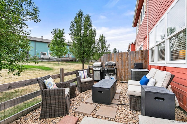 view of patio / terrace with area for grilling and an outdoor living space with a fire pit