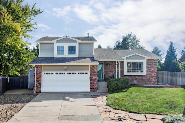 view of front of property with a garage, driveway, brick siding, and fence