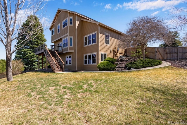 9239 Erminedale Dr, Lone Tree, CO 80124 - rear view of property with a deck, a lawn, fence, and stairway