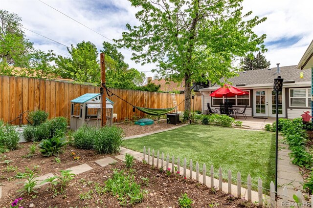 view of yard featuring french doors and a patio