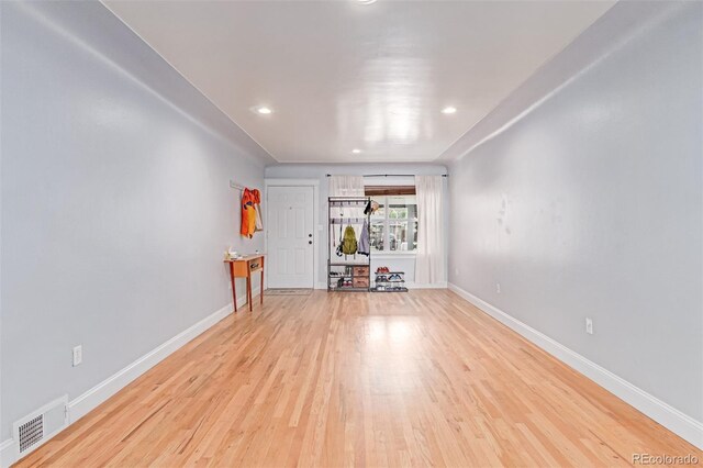 unfurnished living room featuring light wood finished floors, baseboards, and recessed lighting