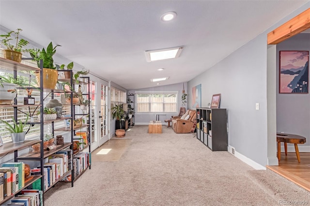 sitting room featuring carpet floors, baseboards, lofted ceiling, recessed lighting, and french doors