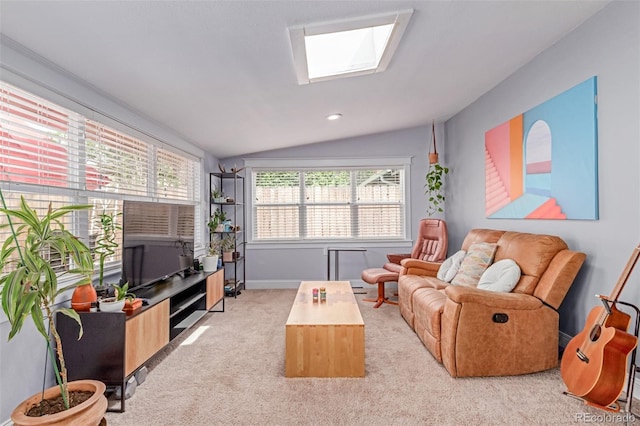 living area featuring vaulted ceiling, a skylight, light colored carpet, and baseboards