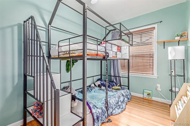 bedroom featuring baseboards and wood finished floors