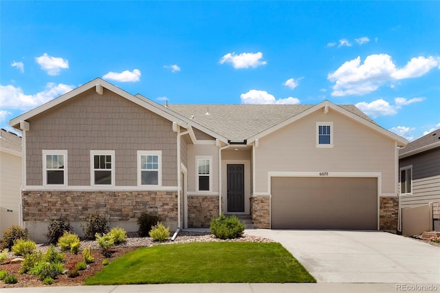 view of front facade with a garage, roof with shingles, concrete driveway, and a front lawn