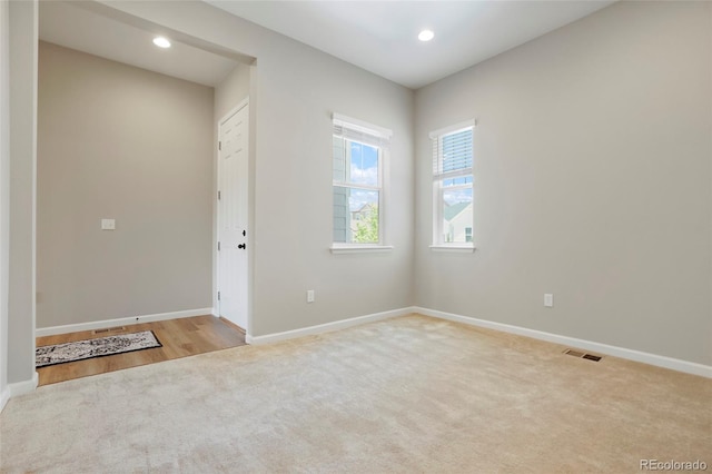 interior space featuring recessed lighting, visible vents, carpet floors, and baseboards