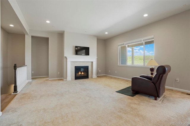 living area with recessed lighting, baseboards, light carpet, and a tile fireplace