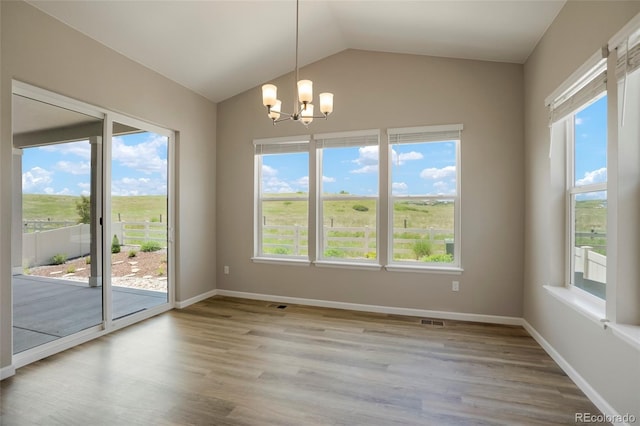 spare room featuring visible vents, a healthy amount of sunlight, light wood-type flooring, and baseboards