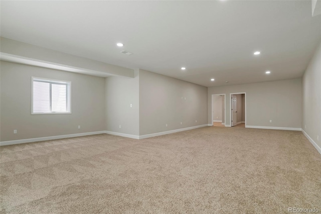 unfurnished room with recessed lighting, baseboards, and light carpet