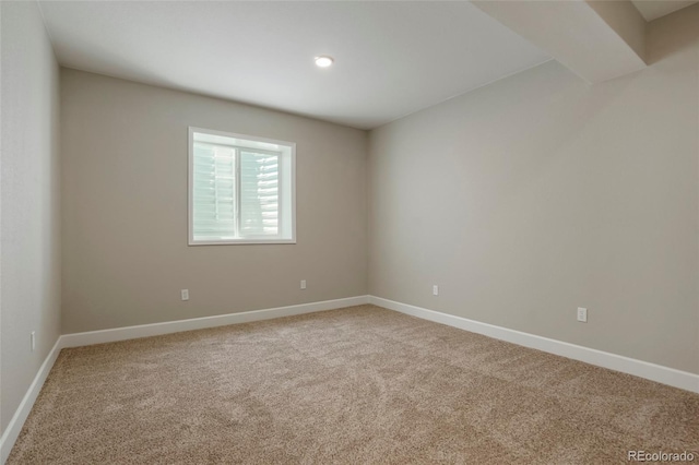 empty room featuring baseboards and carpet floors