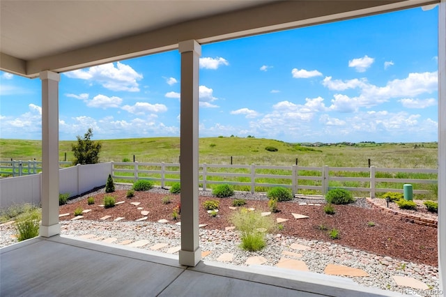 view of yard with a rural view and fence