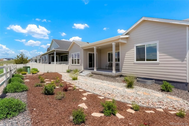 back of house featuring a patio and a fenced backyard