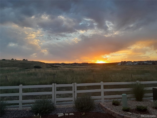 view of yard featuring a rural view and fence