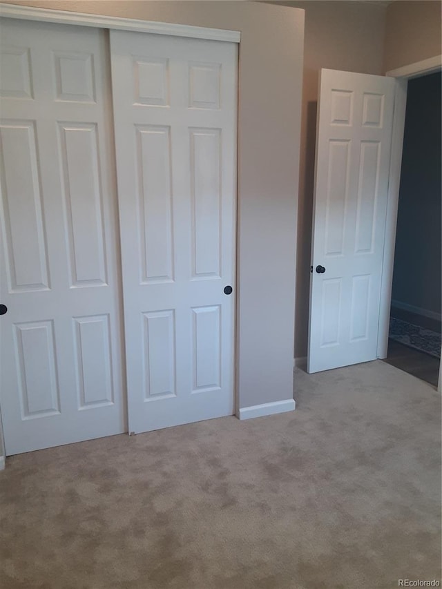 unfurnished bedroom featuring a closet and carpet floors