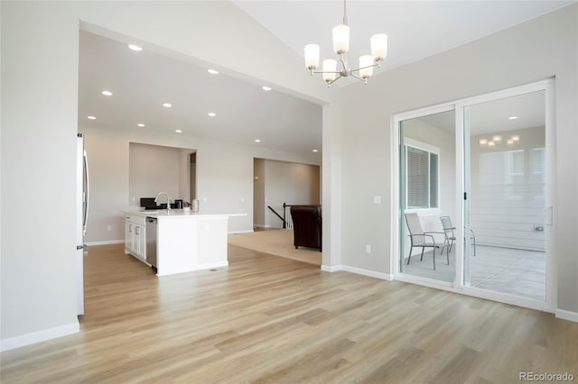 6070 Long Branch Dr, Parker, CO 80134 - unfurnished living room with light wood-style flooring, a chandelier, recessed lighting, baseboards, and vaulted ceiling