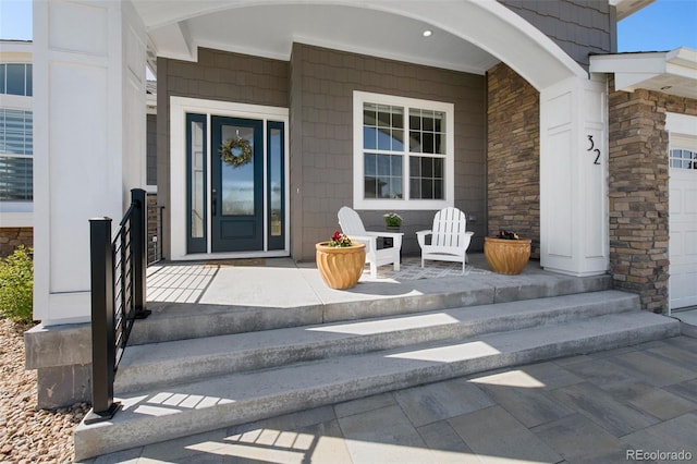 property entrance featuring a porch and stone siding