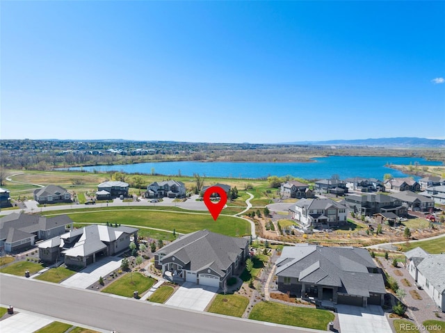 bird's eye view with a residential view and a water view