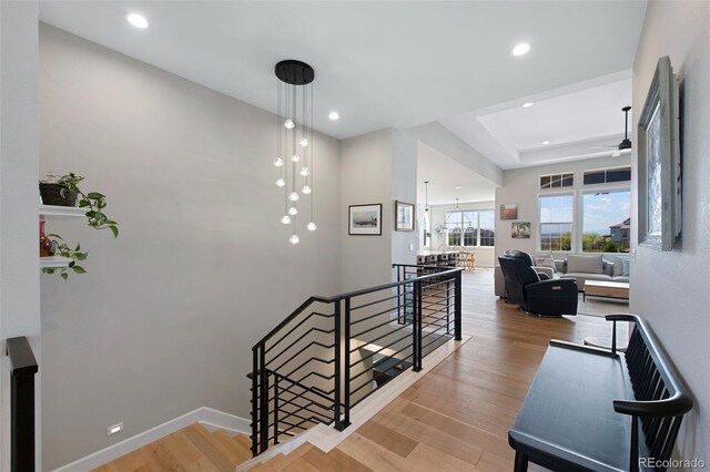 stairs featuring baseboards, a ceiling fan, recessed lighting, and wood finished floors