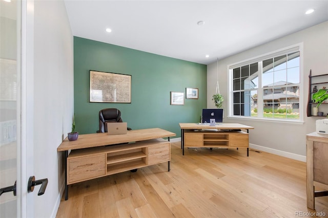 office space with light wood-type flooring, recessed lighting, and baseboards