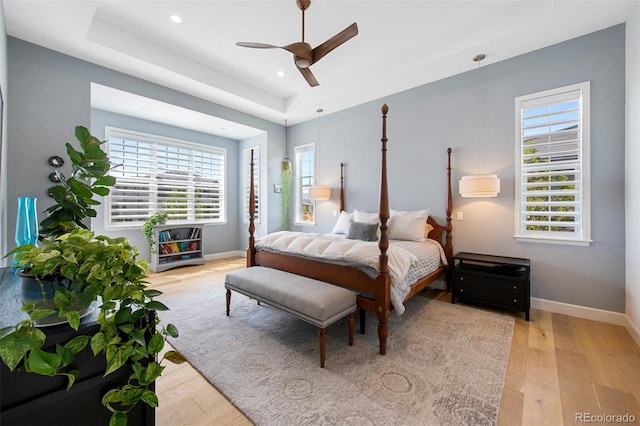 bedroom with recessed lighting, baseboards, multiple windows, and light wood-style flooring