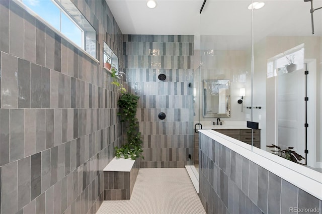bathroom featuring recessed lighting, a tile shower, and vanity