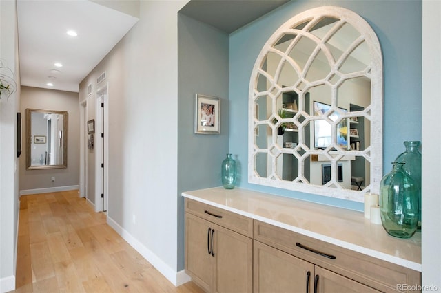 corridor with baseboards, recessed lighting, light wood-style flooring, and visible vents