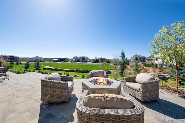 view of patio / terrace featuring a residential view and a fire pit