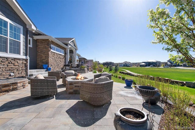 view of patio with a residential view and a fire pit