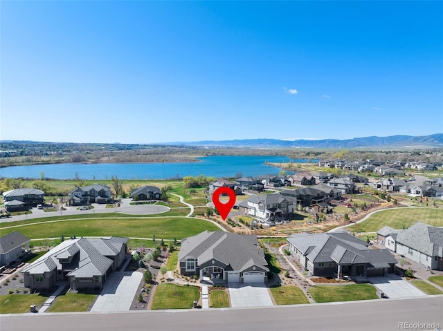 bird's eye view featuring a residential view and a water and mountain view