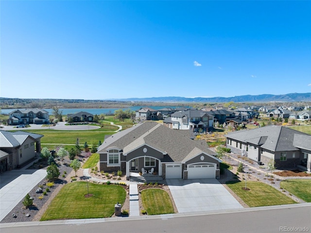 bird's eye view with a water and mountain view and a residential view