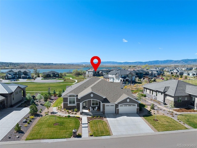 birds eye view of property with a residential view and a water and mountain view