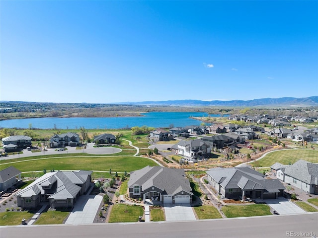 birds eye view of property featuring a residential view and a water and mountain view