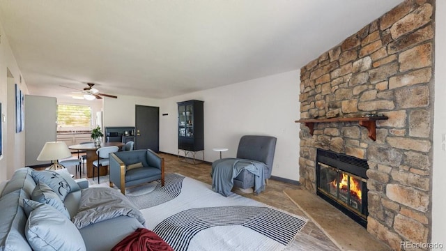 3526 S Depew St Unit 102, Lakewood, CO 80235 - living area with a stone fireplace, a ceiling fan, and wood finished floors