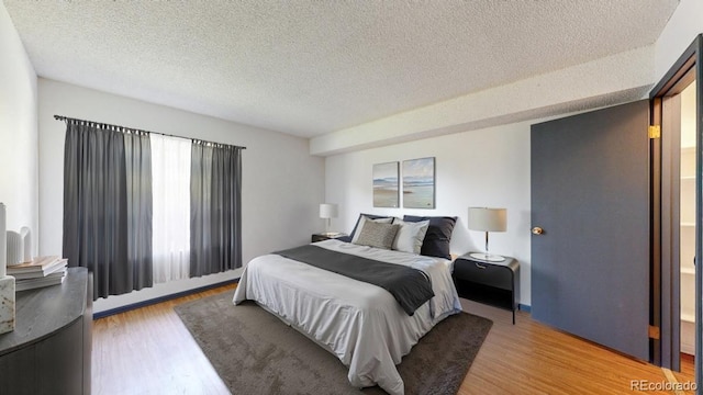 3526 S Depew St Unit 102, Lakewood, CO 80235 - bedroom with light wood-style flooring and a textured ceiling