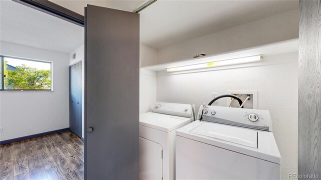 3526 S Depew St Unit 102, Lakewood, CO 80235 - washroom featuring washer and clothes dryer and wood finished floors