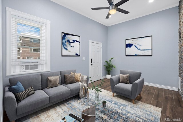 living room featuring ornamental molding, dark hardwood / wood-style flooring, and ceiling fan