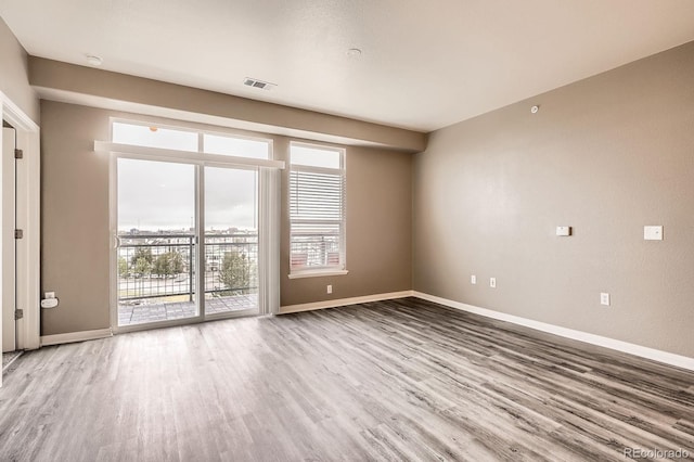 empty room with wood finished floors and baseboards