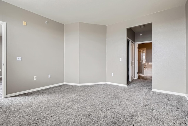 empty room with carpet and baseboards